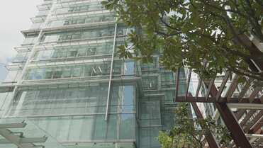 a glass building with trees