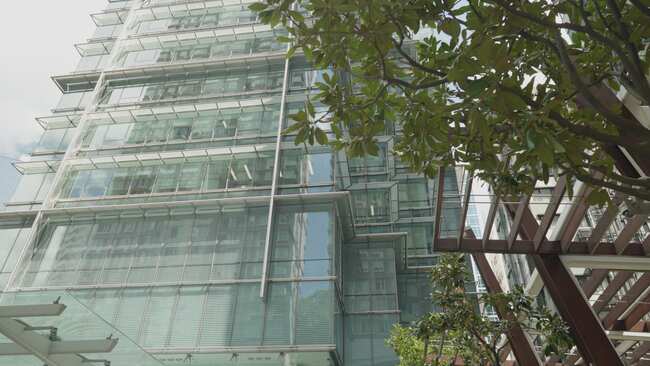 a glass building with trees